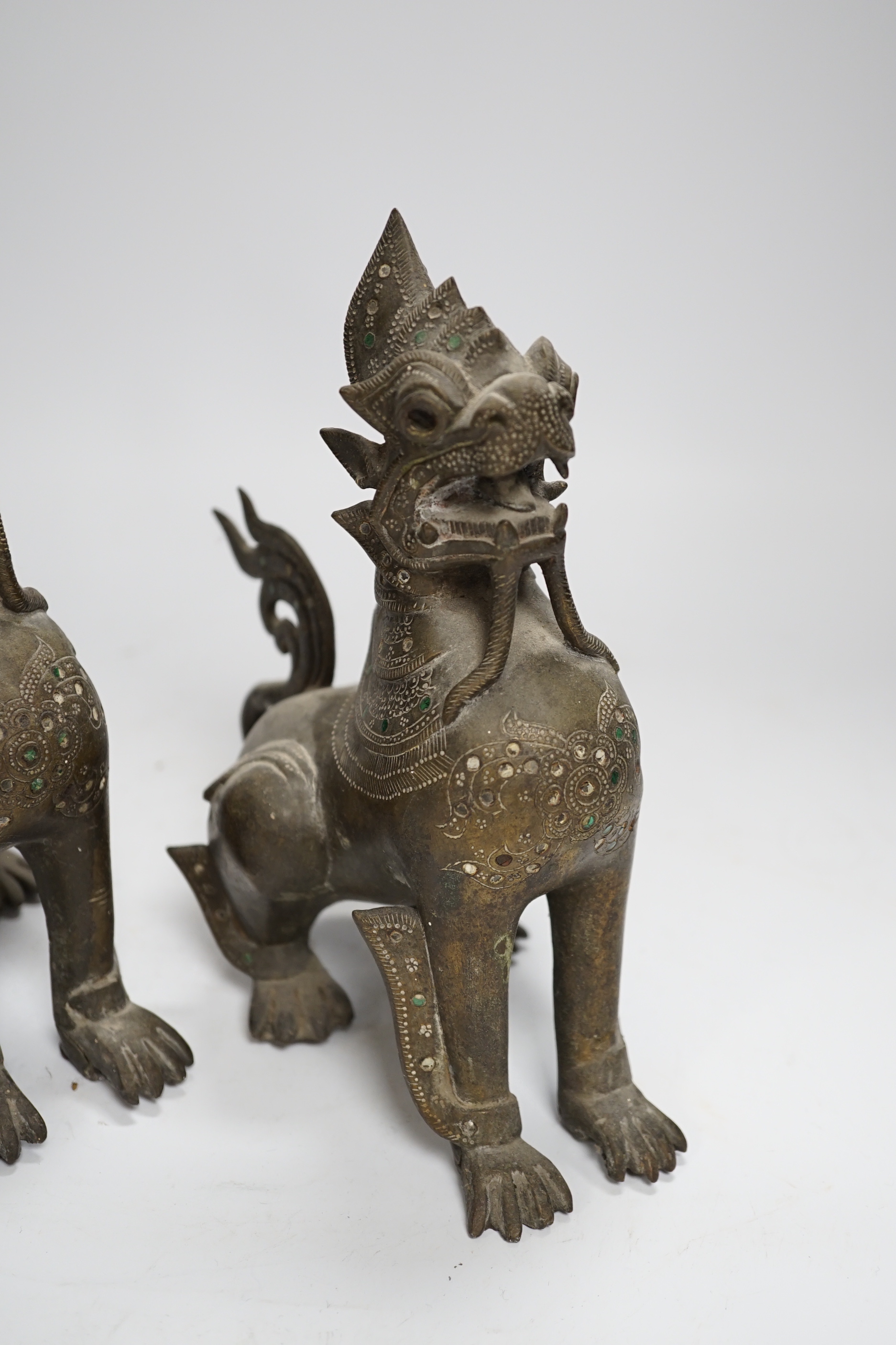 A pair of Thai bronze figures of lion dogs, 20cm